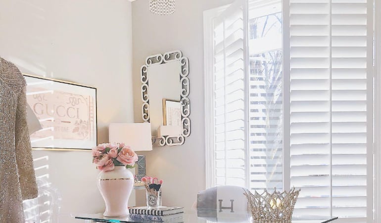 Plantation shutters can provide the perfect light in a home office or for a zoom call. Plantation shutters in a home office.